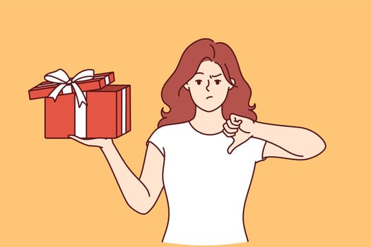 Woman with gift in hands is nervous and points finger down due to poor quality of present. Girl is holding gift tied with ribbon and is embarrassed, feeling offended because of unacceptable surprise.
