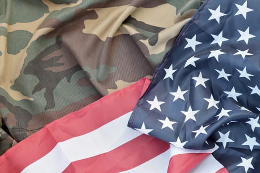 United States of America flag and folded military uniform jacket. Military symbols conceptual background banner for american patriotic holidays design