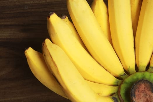 Banana fruit with wooden table on blurred background