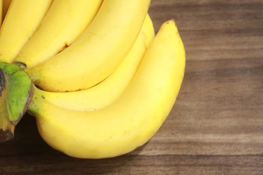 Banana fruit with wooden table on blurred background