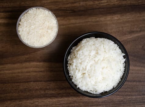 Rice in cup on wooden table blurred background
