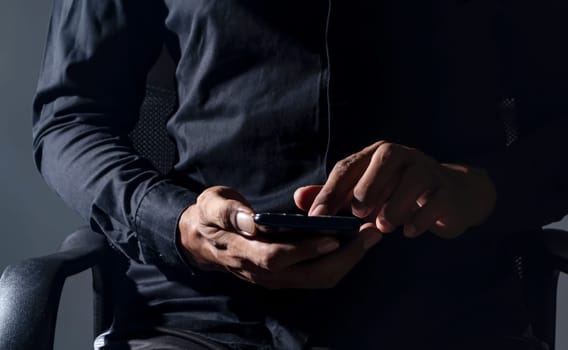 Connecting and communicating people through the network of the Internet, Business man sitting on a work chair with smartphone mobile, Networking people, People's work and transactions occur online and on the internet.