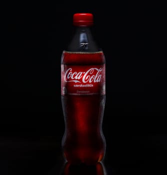 PHUKET, THAILAND - SEP 25, 2023: Coca Cola, a sweet and fizzy soft drink that is popular all over the world, Dark blurred background
