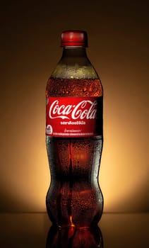 PHUKET, THAILAND - SEP 26, 2023: Coca Cola, a sweet and fizzy soft drink original that is popular all over the world, Dark blurred background