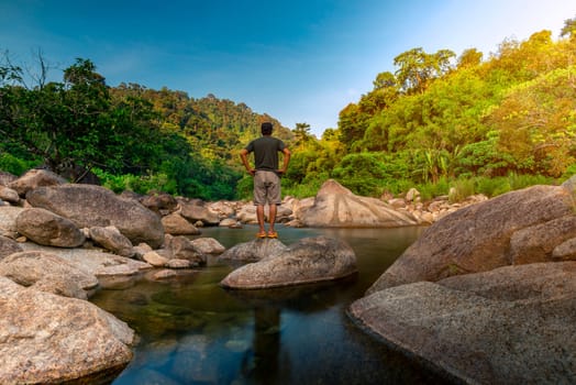 River stone and tree with man relax in sun light, View water river tree, Stone river and sun ray in forest