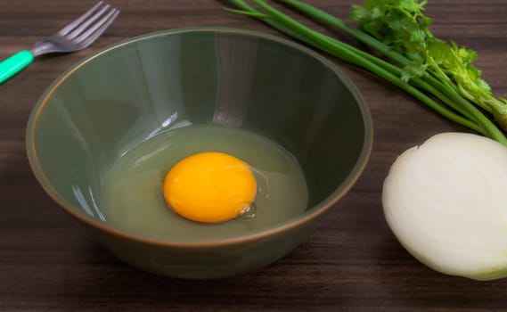 Fresh natural eggs in a bowl with spring onions and coriander to prepare for fried eggs, Omelettes, Egg yolk, Traditional dishes of rural people in Thailand