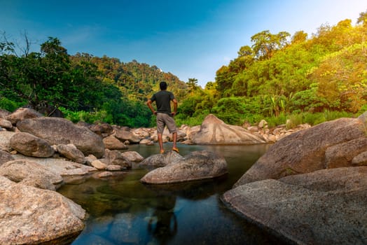 River stone and tree with man relax in sun light, View water river tree, Stone river and sun ray in forest