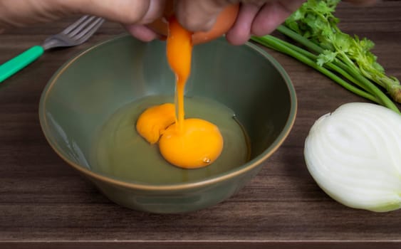Fresh natural eggs in a bowl with spring onions and coriander to prepare for fried eggs, Omelettes, Egg yolk, Traditional dishes of rural people in Thailand