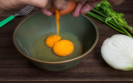 Fresh natural eggs in a bowl with spring onions and coriander to prepare for fried eggs, Omelettes, Egg yolk, Traditional dishes of rural people in Thailand