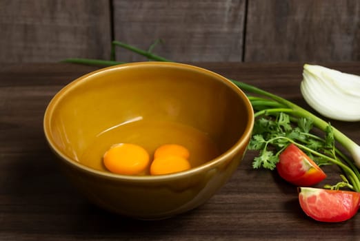 Fresh natural eggs in a bowl with spring onions and coriander to prepare for fried eggs, Omelettes, Egg yolk, Traditional dishes of rural people in Thailand