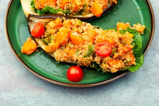 Stuffed eggplants with pumpkin, tomatoes and quinoa on a plate.