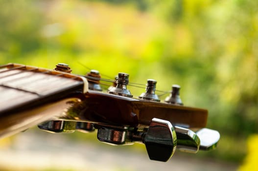 Close up of Guitar with nature background. Customizable space for text or ideas. Copy space.