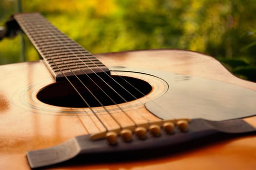 Close up of Guitar with nature background. Customizable space for text or ideas. Copy space.