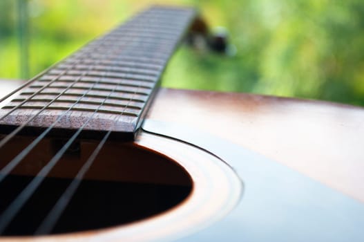 Close up of Guitar with nature background. Customizable space for text or ideas. Copy space.