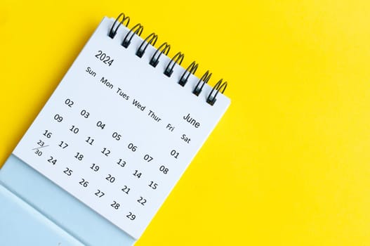 June 2024 table calendar on yellow cover background with customizable space for text