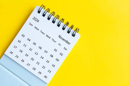 November 2024 table calendar on yellow cover background with customizable space for text
