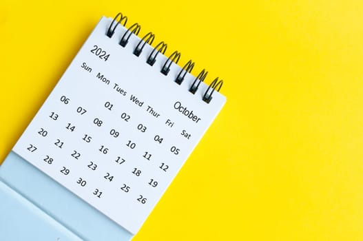 October 2024 table calendar on yellow cover background with customizable space for text