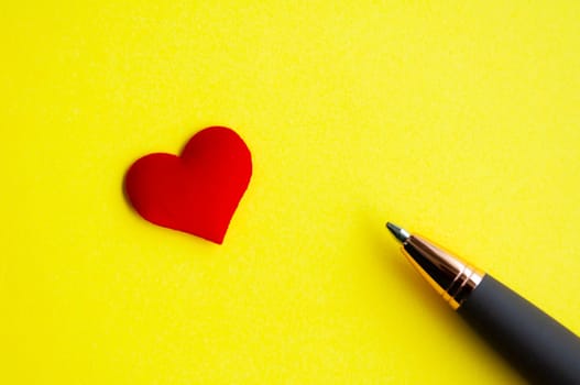 Heart shape and pen on yellow background cover with customizable space for text or message. Love concept and copy space