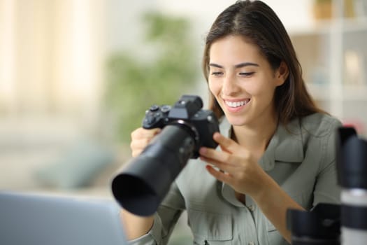Happy photographer at home checking result on mirrorless camera