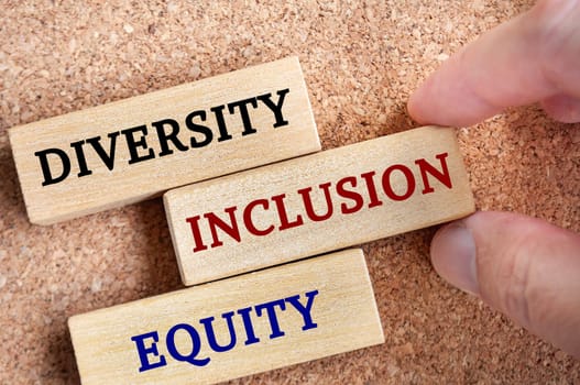 Top view of wooden blocks with text - Diversity, inclusion and equity. Diversity concept
