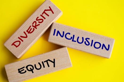 Top view of close up wooden blocks with text - Diversity, inclusion and equity. Diversity concept