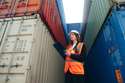 Woman Works in international shipping area Export and import delivery service with containers