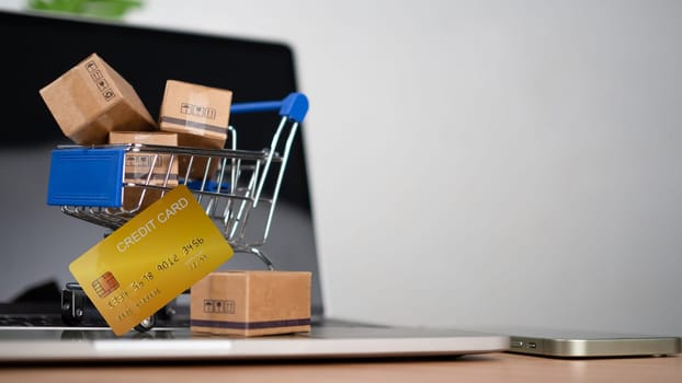 Shopping carts and credit card Place on laptop computer repressents online shopping concept, website, e-commerce, market platform, technology and online payment concept.