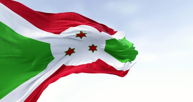 National flag of Burundi waving on a clear day. White diagonal cross dividing into red and green sections, three green stars in the center. 3d illustration render. Fluttering fabric. Selective focus