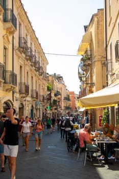Sicily, Taormina, Italy - 28 September 2023. Tourists in the main street Corso umberto in Taormina. City views, facades, architecture and the most popular streets.