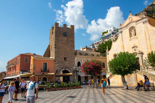 Sicily, Taormina, Italy - 28 September 2023. City views, facades, architecture and the most popular streets. Tourists at Mainsquare Piazza IX Aprile and San Giuseppe church.