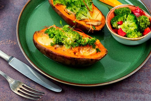 Vegetarian dish, baked sweet potato stuffed with mushrooms, broccoli and peppers. Copy space.