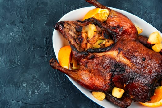 Whole duck baked with oranges and caramelized apples.