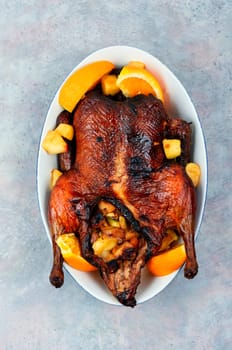Whole duck baked with oranges and caramelized apples.