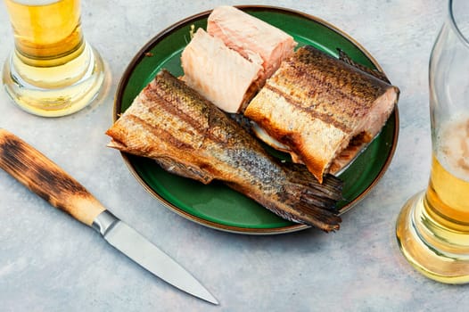 Dietary hot smoked trout salmon cut on a plate. Top view