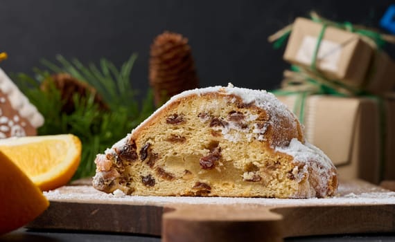 Christmas pastries stollen sprinkled with powdered sugar on the table, festive dessert
