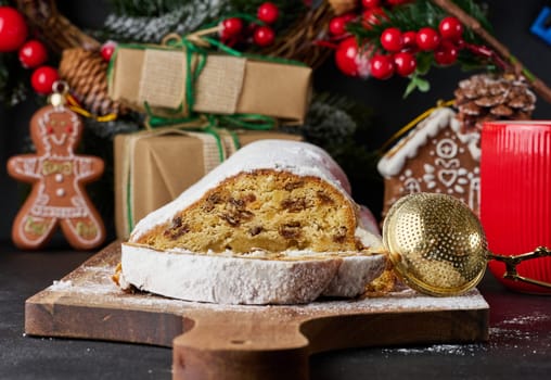 Christmas pastries stollen sprinkled with powdered sugar on the table, festive dessert