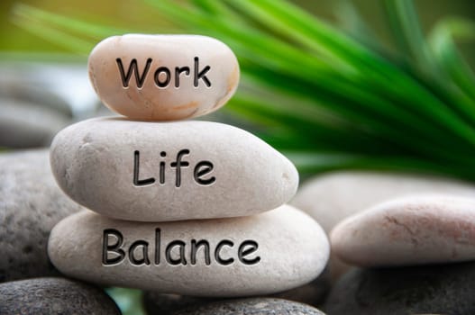 Work life balance text engraved on white zen stones. Work, lifestyle and life balance concept