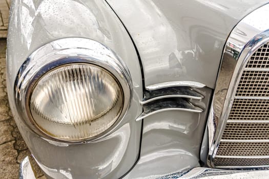 WETTENBERG, HESSE, GERMANY - 07 - 28 - 2023: Front Headlight from vintage MERCEDES BENZ at a traditional Car show in Krofdorf-Gleiberg, near Giessen, Hesse.