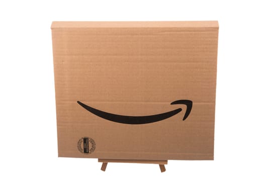 HUETTENBERG, HESSE, GERMANY - 05-23-2023- Amazon arrow on cardboard. Amazon is an American electronic commerce and cloud computing company.