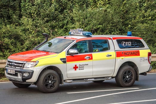 WETTENBERG, HESSE, GERMANY - 07 - 28 - 2023: German Red Cross emergency ambulance on a street in Krofdorf-Gleiberg, near Giessen, Hesse.