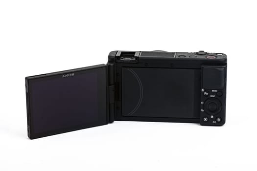 HUETTENBERG, HESSE, GERMANY 06-02-2023: SONY ZV VLOG CAMERA ZV 1. Opened display of the Sony ZV-1 isolated on white background