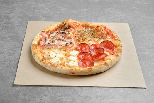 Classic pizza four seasons on parchment paper