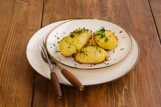 Portion of crispy hasselback potato on a plate