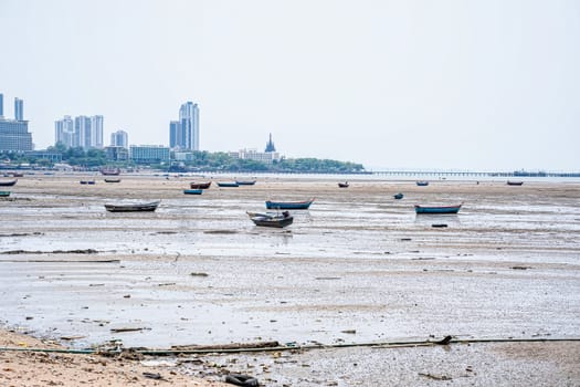 Many fishing boats are moored on the beach.