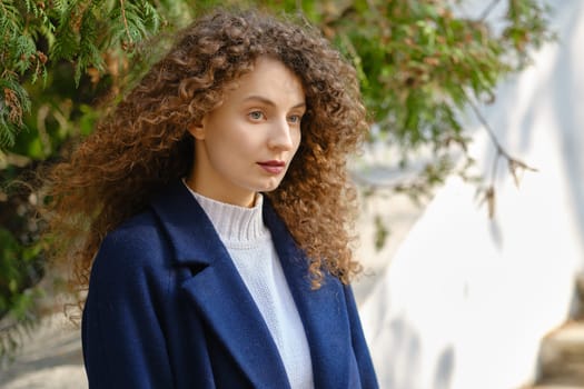 Outdoor portrait of young cute woman in coat