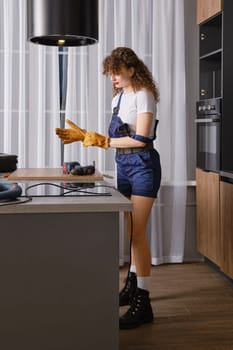 Woman putting on gloves before working with work tools