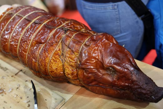 Baked suckling pig whole on a wooden board