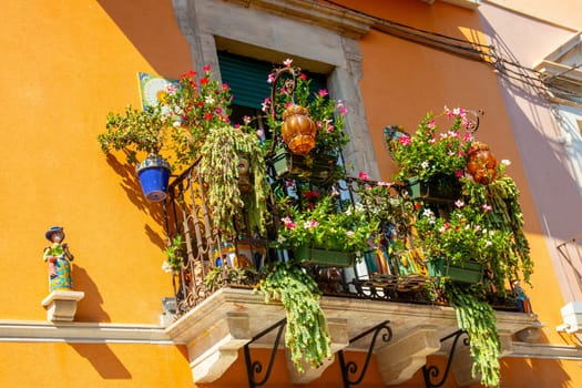 Sicily, Taormina, Italy - 28 September 2023. A beautifully decorated balcony on a townhouse in the main street Corso umberto in Taormina. City views and facades.