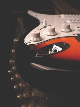 Vintage electric guitar on an old guitar amplifier in a studio