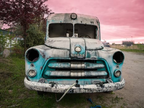 HENGELO, NETHERLANDS - MAY 2, 2023: Old and broken dodge ambulance car used as an art object